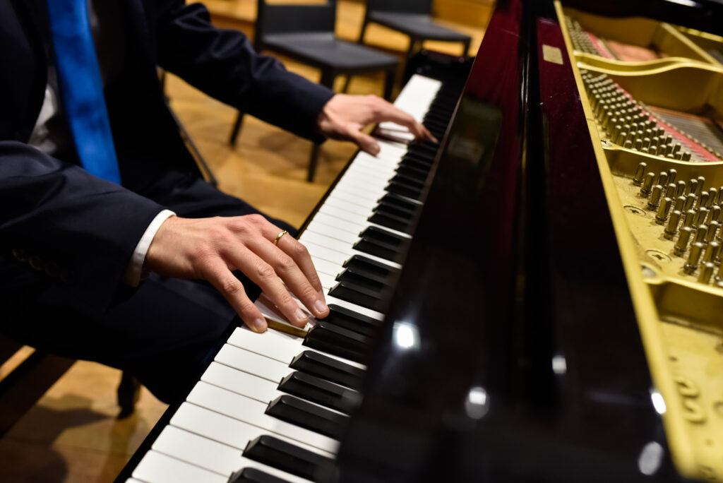 Pianiste professionnel interprétant un morceau sur un piano à queue.